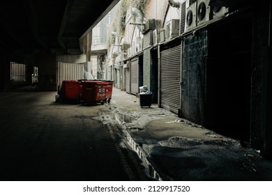 Manchester UK February 2022 dirty back alley street in the city centre back of business with wheeled bins 