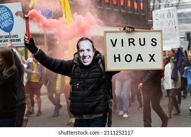 Manchester UK. January 22, 2022. Anti Vax Protest Deansgate. Protester Holding Sign Text Virus Hoax.