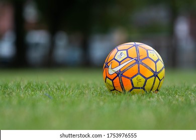 Manchester / UK - June 2020: Close of a Nike yellow and orange football with the English Premier League badge. The Premier League is due to start again on the 17th June 2020. 