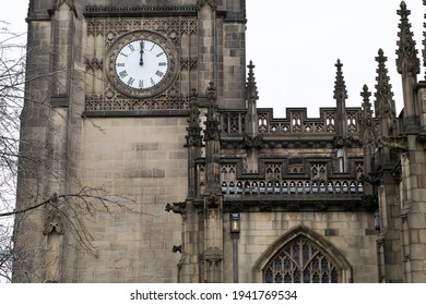 Manchester UK. March 23, 2021. Manchester Cathedral With Clock Showing Noon At Start Of A Minutes Silence Marking One Year Anniversary Of Lockdown 