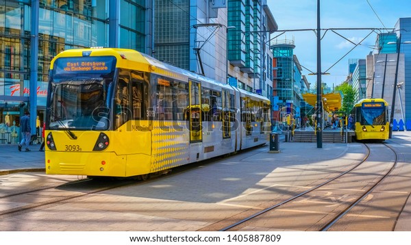 Manchester, UK - May 18\
2018: Light rail Metrolink tram in the city center of Manchester,\
UK. The system has 77 stops along 78.1 km and runs through seven of\
the ten boroughs