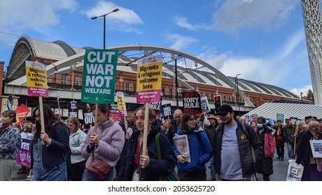 Manchester UK. October 3, 2021. Tory Party Conference Protest Marching In Front Of Manchester Central Conference Venue With Sign Text Cut War Not Welfare And Migrants Welcome Here