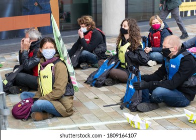 Manchester, UK. September 5, 2020. Extinction Rebellion Free The Truth Protest At Media City, Salford Quays. Protesters Sitting In A Chalk Outline Of A Boat. Refugee And Climate Change Representation.