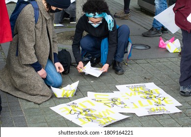 Manchester, UK. September 5, 2020. Extinction Rebellion Free The Truth Protest At Media City, Salford Quays. Protester Making Paper Boat Using Old Poster.