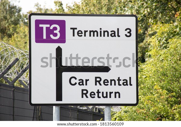 Manchester, United Kingdom - 12th Sept 2020:\
Traffic sign in white for terminal 3 at Manchester Airport in the\
United Kingdom with information on car\
rental.