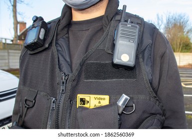 Manchester, United Kingdom  - 26th Nov 2020: A Man Wearing A Black Equipment Vest With A Body Cam And Walkie Talkie Attached.