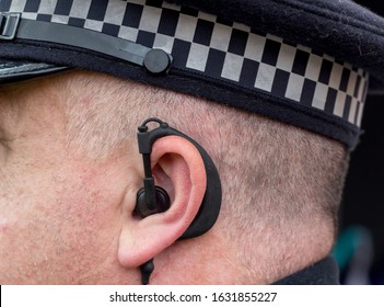 Manchester, United Kingdom - 31st Jan 2020: Close Up Of A British Police Officer Wearing A Radio Ear Piece.