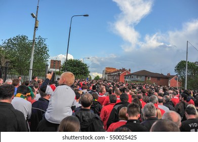 Manchester, United Kingdom - May 07, 2011: Manchester United Supporter Walking On Barlow Road In Front Of Old Trafford Stadium,  Manchester, United Kingdom.