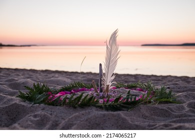 Mandala on ground. Making a mandala of natural elements on a beach. Handmade nature art pattern. - Shutterstock ID 2174065217
