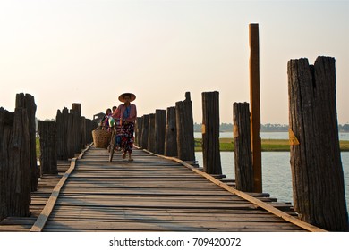 MANDALAY-APRIL17:A villager is walking on the U bein bridge in the morning at rural area of Mandalay 14 APRIL 2017 - Shutterstock ID 709420072