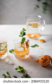 Mandarin orange fresh lemonade. Food cocktail photo with fruit slices in carafe decanter vertical photo with detox beverage - Shutterstock ID 2086933120
