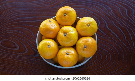 Mandarin Oranges On A Wood Grain Table.