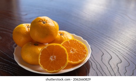 Mandarin Oranges On A Wood Grain Table.