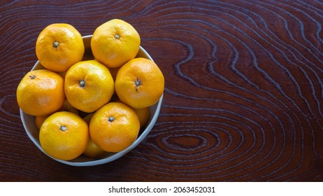 Mandarin Oranges On A Wood Grain Table.