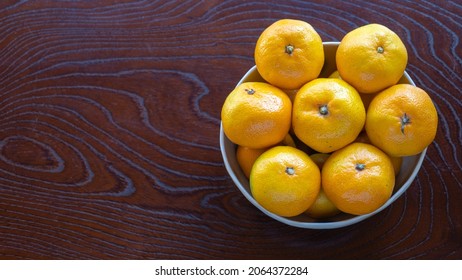 Mandarin Oranges On A Wood Grain Table.