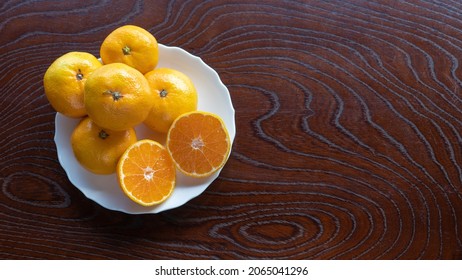 Mandarin Oranges On A Wood Grain Table.