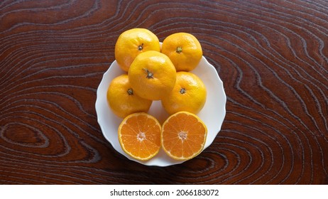 Mandarin Oranges On A Wood Grain Table.