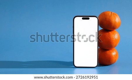 mandarins in vertical stack beside smartphone, simulating quick grocery order placement via delivery app