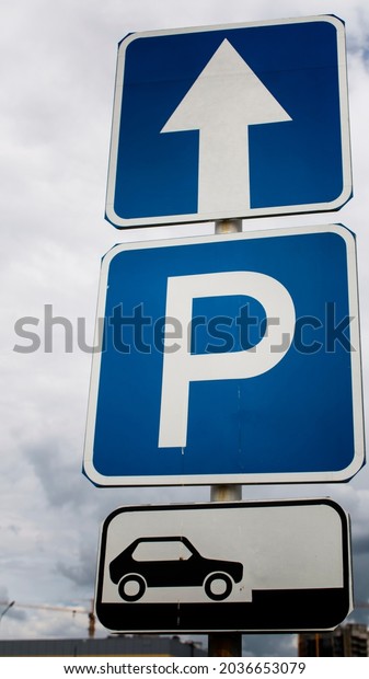 Mandatory and information signs. Proceed straight.\
Parking sign.