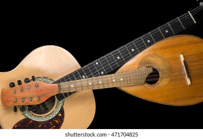 Mandolin and guitar on a black background. Stringed Musical Instruments.