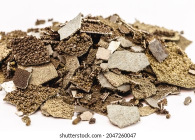 Manganese samples, flaked pure manganese metal used in industry, isolated white background.