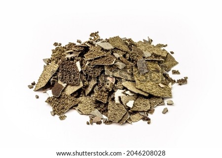 Manganese samples, flaked pure manganese metal used in industry, isolated white background.