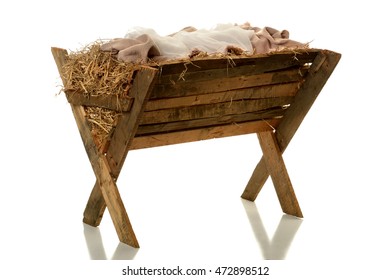Manger with hay and fabrics isolated over white background