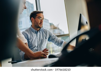 Manger Helping Coworker Working On New Project. Business People Working Together In Computer.