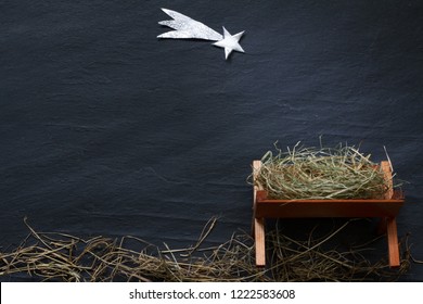 Manger and star of Bethlehem abstracy christmas background nativity scene on black marble