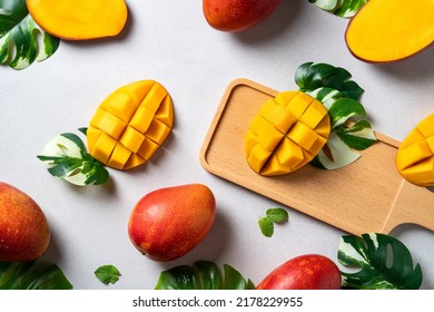 Mango Background Design Concept. Top View Of Diced Fresh Mango Fruit Pattern With Leaves On Gray Table.