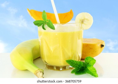 Mango Banana Smoothie With Stevia And Mint In Sky Background