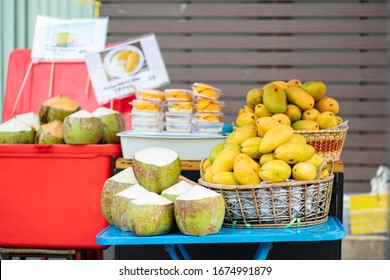 Mango in basket and coconut on table for sale in fresh market