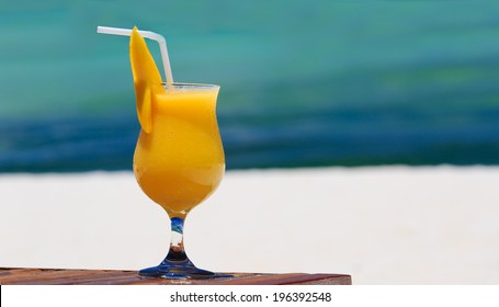 Mango Cocktail On Blue Tropical Beach