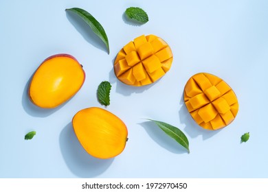 Mango Design Concept. Top View Of Diced Fresh Mango Fruit Pattern On Blue Table Background.