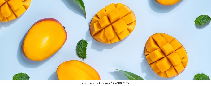 Mango Design Concept. Top View Of Diced Fresh Mango Fruit Pattern On Blue Table Background.