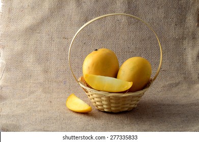 Mango fruit in basket on sack cloth 
