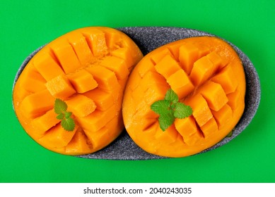 Mango Fruit Flesh Cut Into Cubes On Green. Ripe Fruit Served