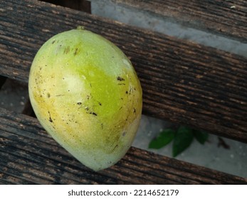 Mango Fruit Ripe Tree. Yellow Mango Is Placed On Wooden Bench. Top View.