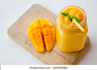 mango in a glass jar Mason on the old wooden background