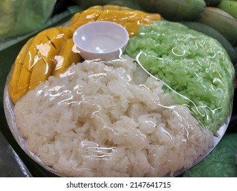 Mango With Green And White Sticky Rice. Thai Style Tropical Dessert In Plastic Wrap. Food Was Prepared For The Wedding Dinner.