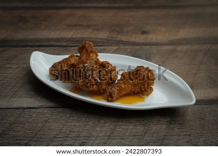 mango habenero hot wings on a wooden background