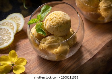 Mango ice cream. Mango ice cream balls in a transparent glass garnished with mint leaves.
 - Powered by Shutterstock