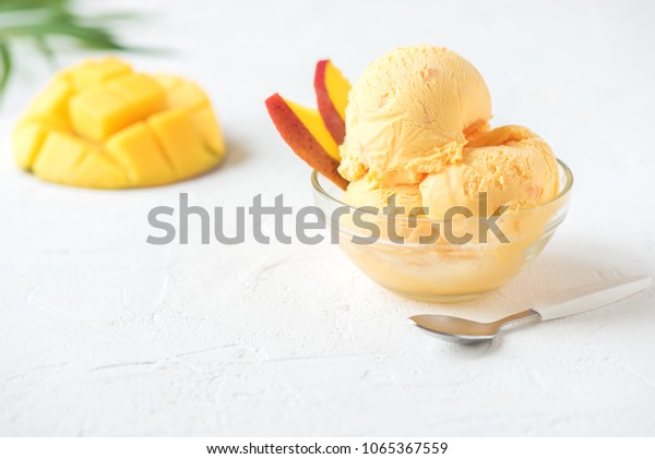 Mango Ice Cream or Sorbet
in bowl. Homemade fruit mango ice cream on white background, copy
space.