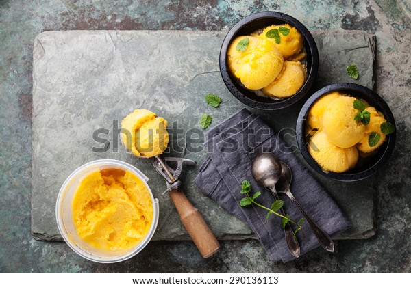 Mango-Eiscreme-Sorbet mit Minzblättern in schwarzen Schalen, Stockfoto ...