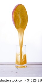 Mango Juice Pouring Into A Glass
