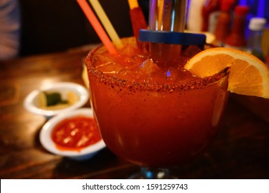 Mango Michelada With Tajin Rim And Orange Slice