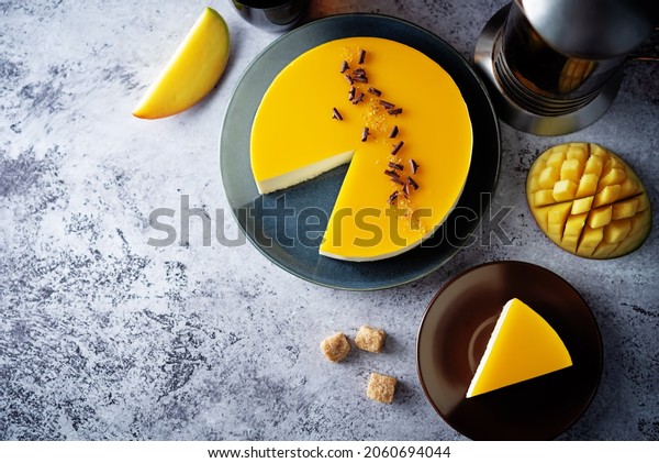 Mango mousse cake in a plate with mango slices.\
toning. selective focus