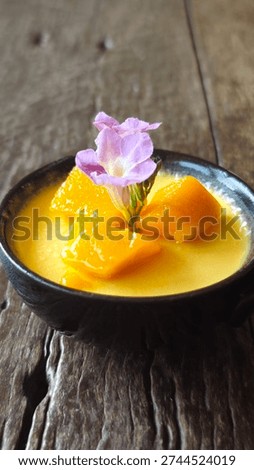 Mango panna cotta pudding with diced mango.