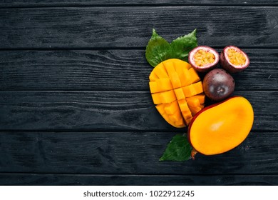 Mango And Passion Fruit. Fresh Tropical Fruits. On A Wooden Background. Top View. Copy Space.