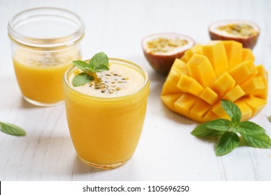 mango and passion fruit smoothies on wooden background